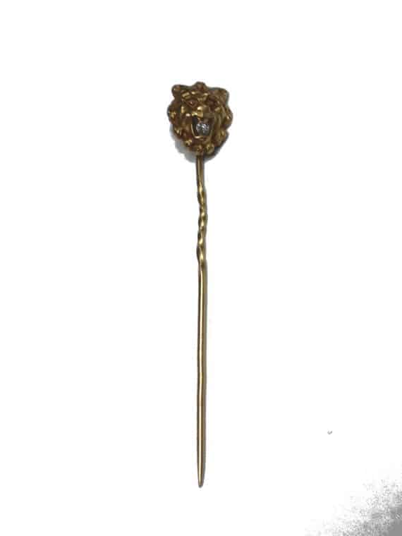 A gold mask stickpin